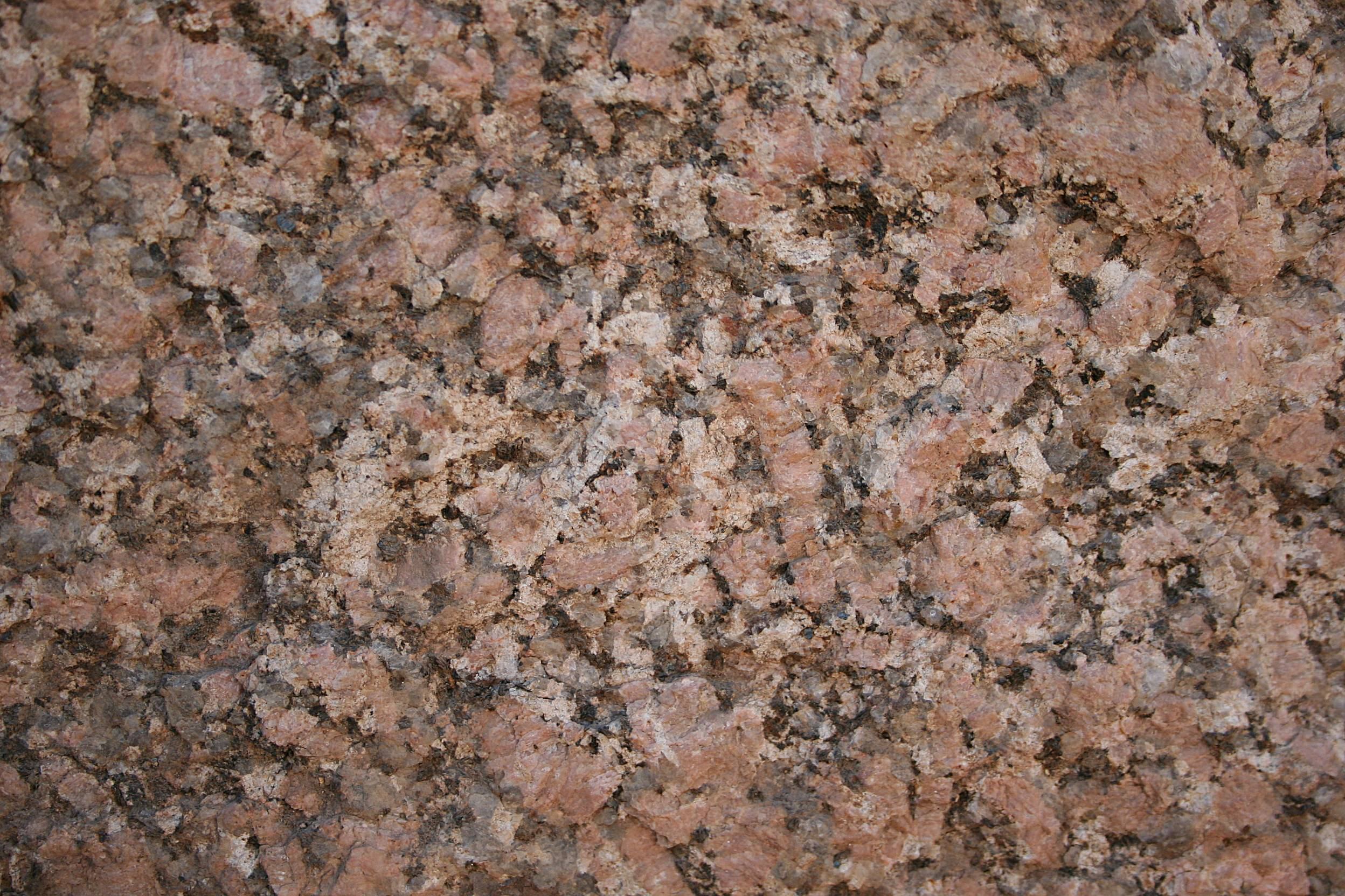 Close-up of pink Aswan granite at the ancient obelisk quarry, showing large feldspar crystals